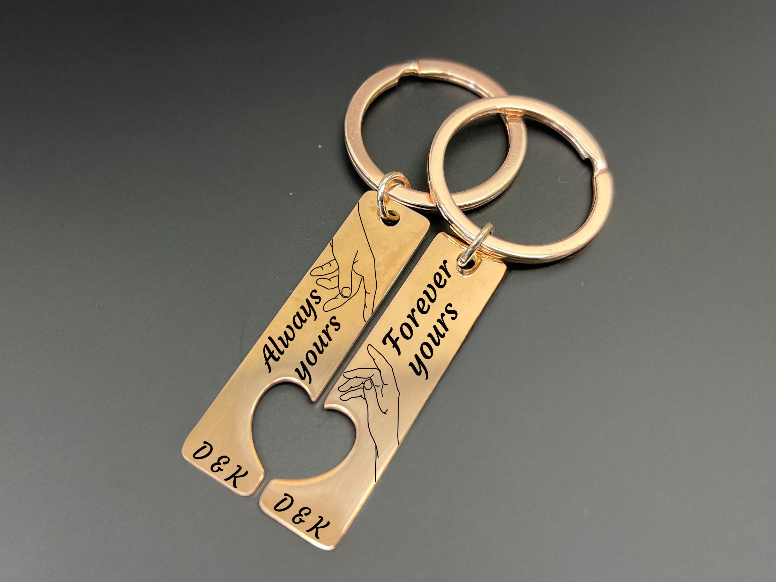 Personalised rose gold couple keyring set engraved with “Always yours” and “Forever yours,” connecting hand illustration, and custom initials