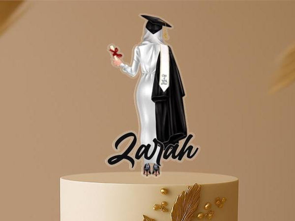 Personalised Muslim graduation cake topper with hijabi female graduate in cap and gown, custom name, and Class of 2025 on elegant two-tier cake.