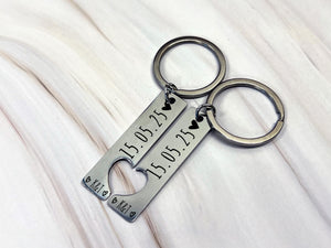 Close-up of engraved keyring details, custom date and initials, high-quality stainless steel, perfect gift for couples.