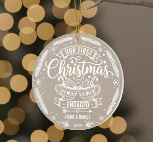 A round ornament with a white and gold design hangs against a blurred background with bokeh lights.