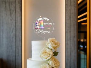 a birthday cake with white roses on a table
