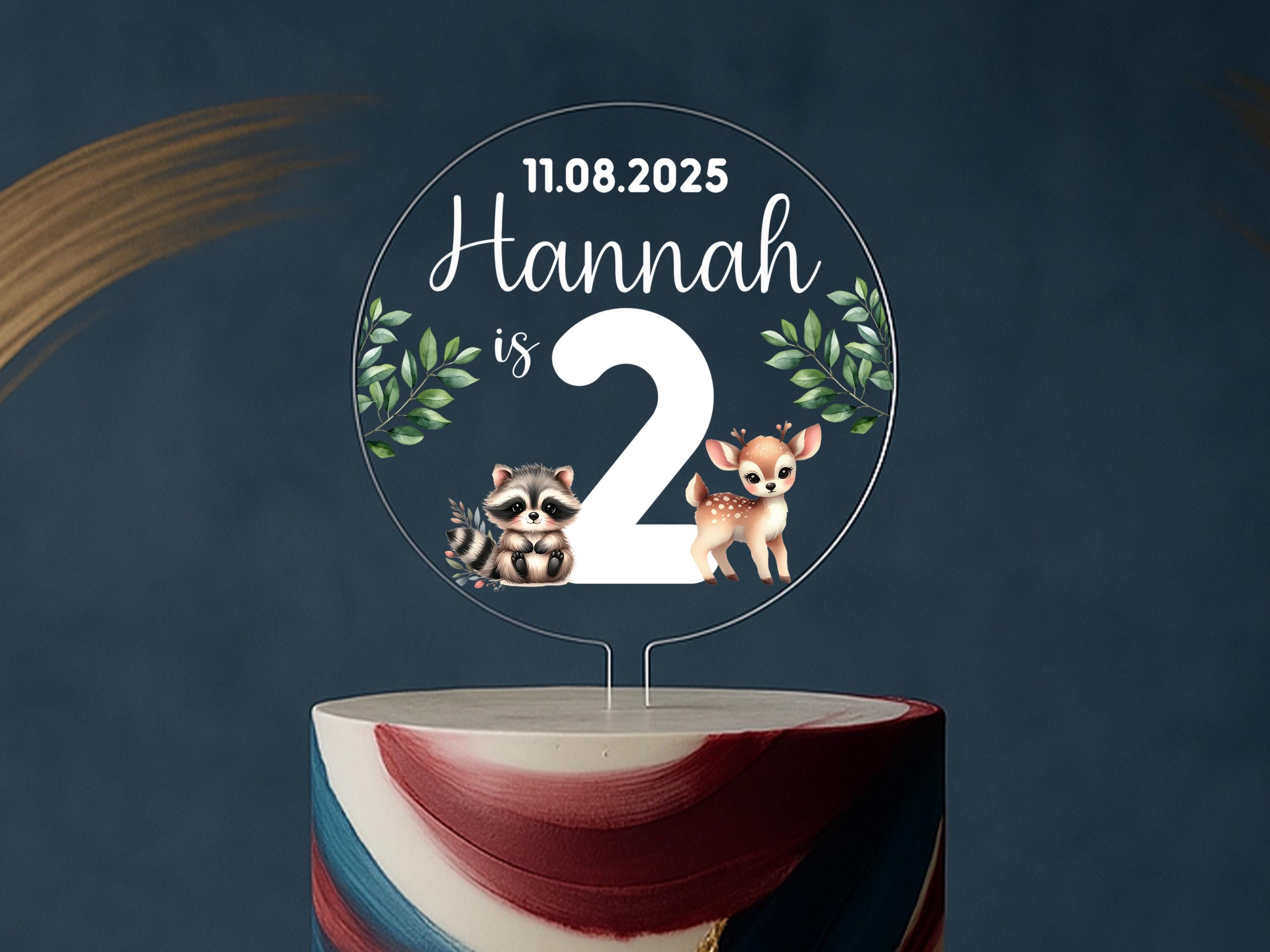a cake with a cake topper that says hannah is 2
