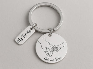 Keepsake keychain for Father’s Day featuring parent-child hands