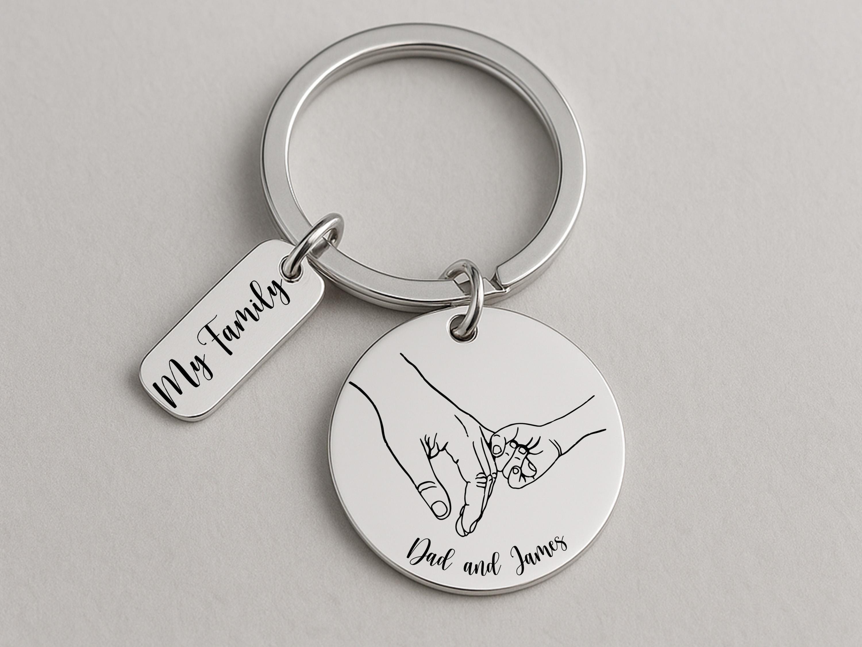 Keepsake keychain for Father’s Day featuring parent-child hands