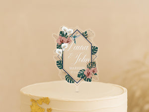 A white wedding cake with a decorative floral topper featuring the names "Lena & John" and the date "MARCH 17, 2020".