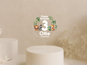 Close-up of safari-themed birthday cake topper with vibrant animal illustrations and custom text.