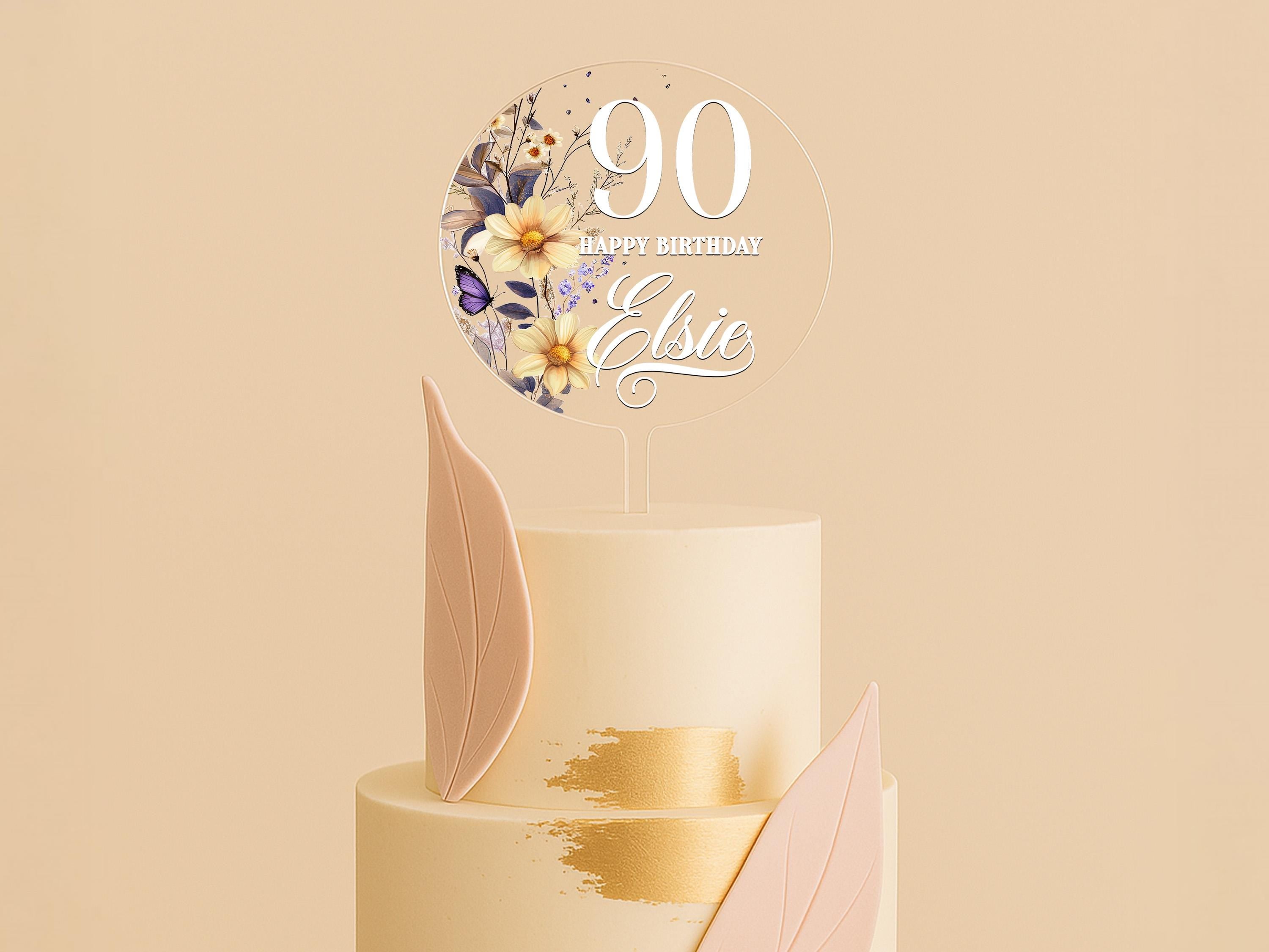 a three tiered cake with a white frosting and gold decoration