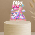 Custom unicorn birthday cake topper featuring rainbow number 7 with magical unicorn, flowers and personalised name Mia on buttercream cake