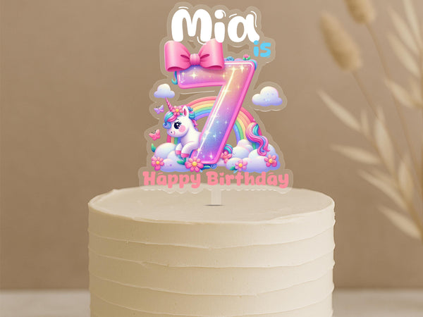 Custom unicorn birthday cake topper featuring rainbow number 7 with magical unicorn, flowers and personalised name Mia on buttercream cake