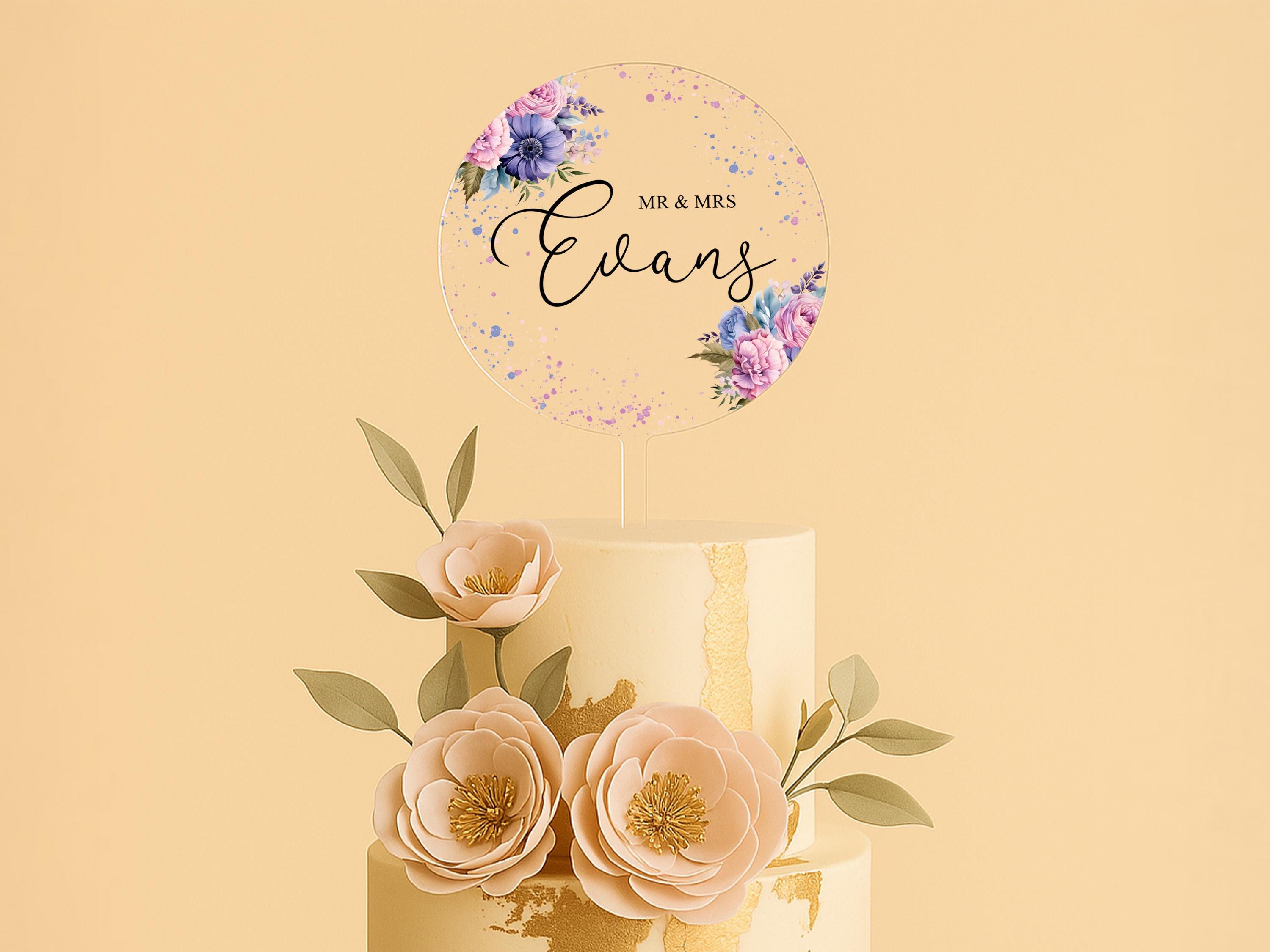 a three tiered cake with flowers on top