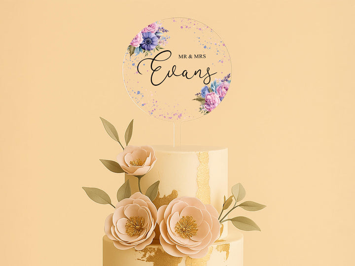 a three tiered cake with flowers on top