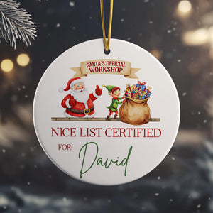 A white ornament with a Santa Claus and an elf, along with a "NICE LIST CERTIFIED FOR: David" inscription.