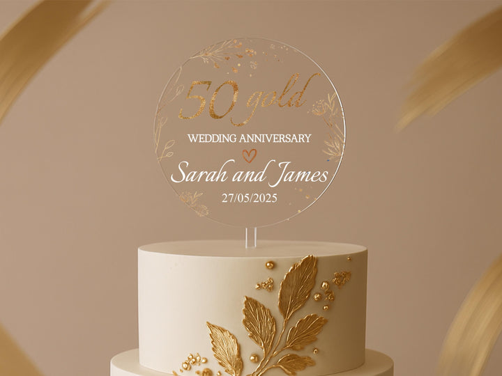 a white and gold wedding cake with gold leaves