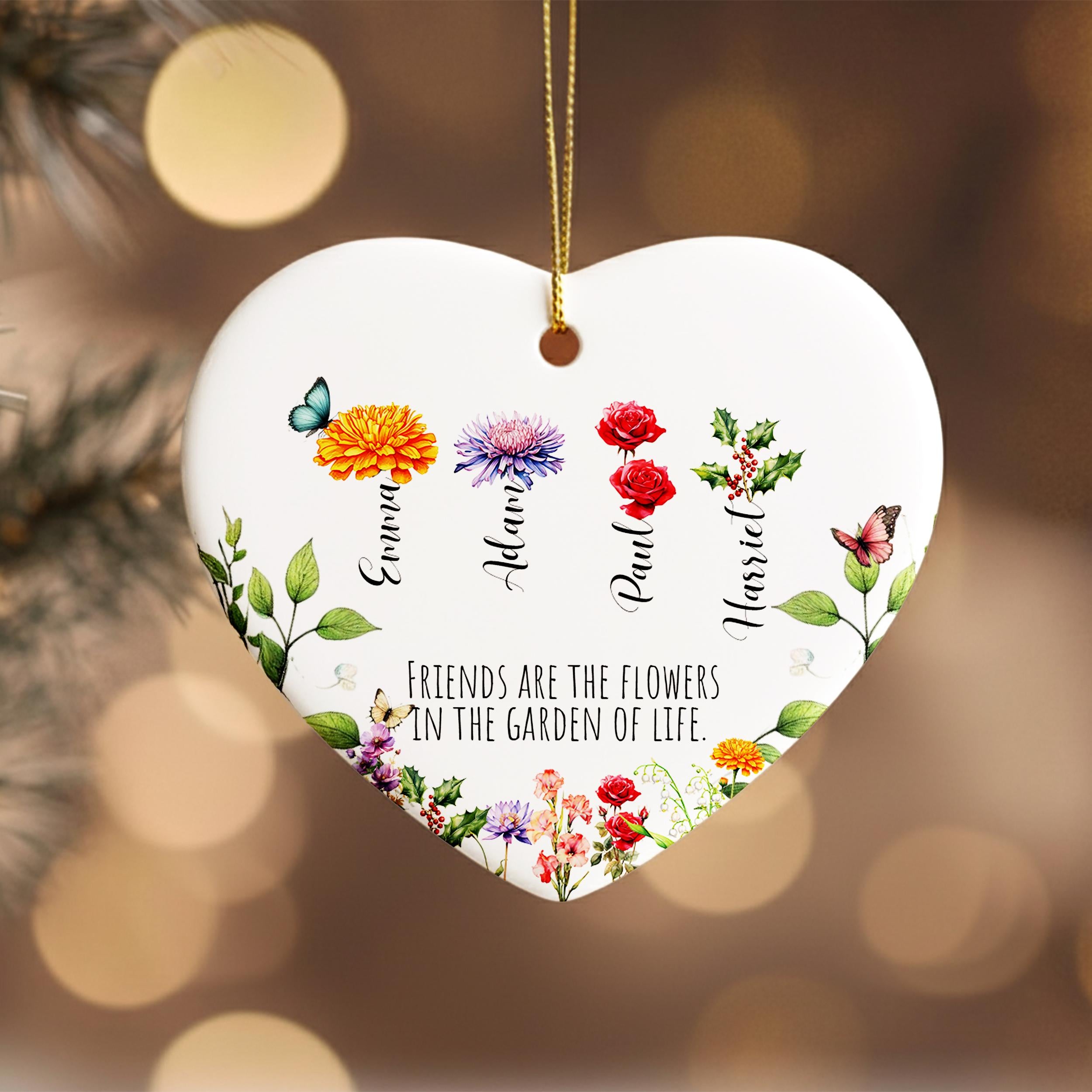 A heart-shaped ornament with a floral design and the text "Friends are the flowers in the garden of life" printed on it.