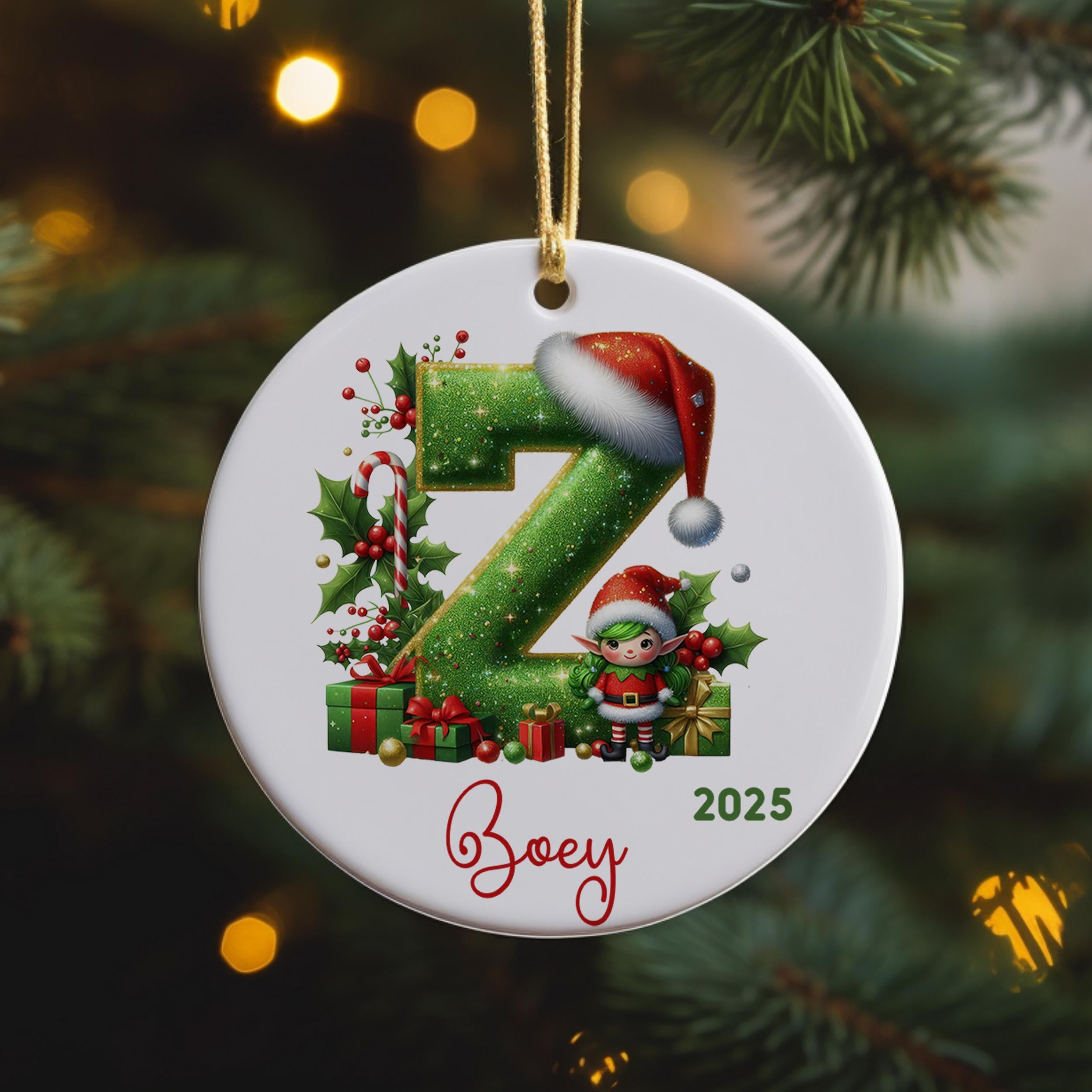 A white ornament with a green letter "Z" and a small elf wearing a Santa hat, surrounded by Christmas decorations such as presents and holly leaves.