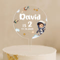 a cake with a cake topper that says david is 2