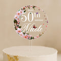 a birthday cake with a white frosting and pink flowersRound 50th birthday cake topper with pink floral ring and butterflies