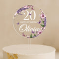 a cake with a white frosting and purple flowers on it