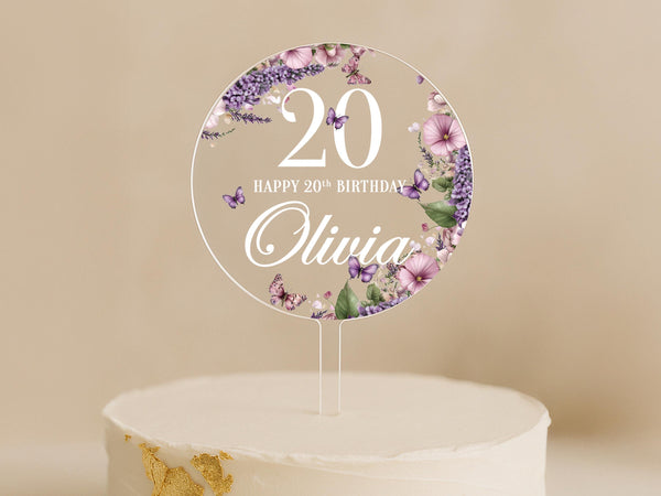 a cake with a white frosting and purple flowers on it