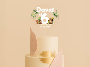 a three tiered cake with a topper on it