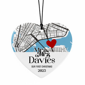 A heart-shaped ornament with a map of a city and a red heart symbol, along with the text "Mrs & Mrs Davies" and "OUR FIRST CHRISTMAS 2025".