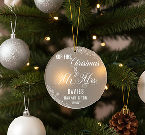 A Christmas tree decorated with ornaments, including a large ornament that reads "Our first Christmas as Mr & Mrs Davies Hannah & Tom 2025".