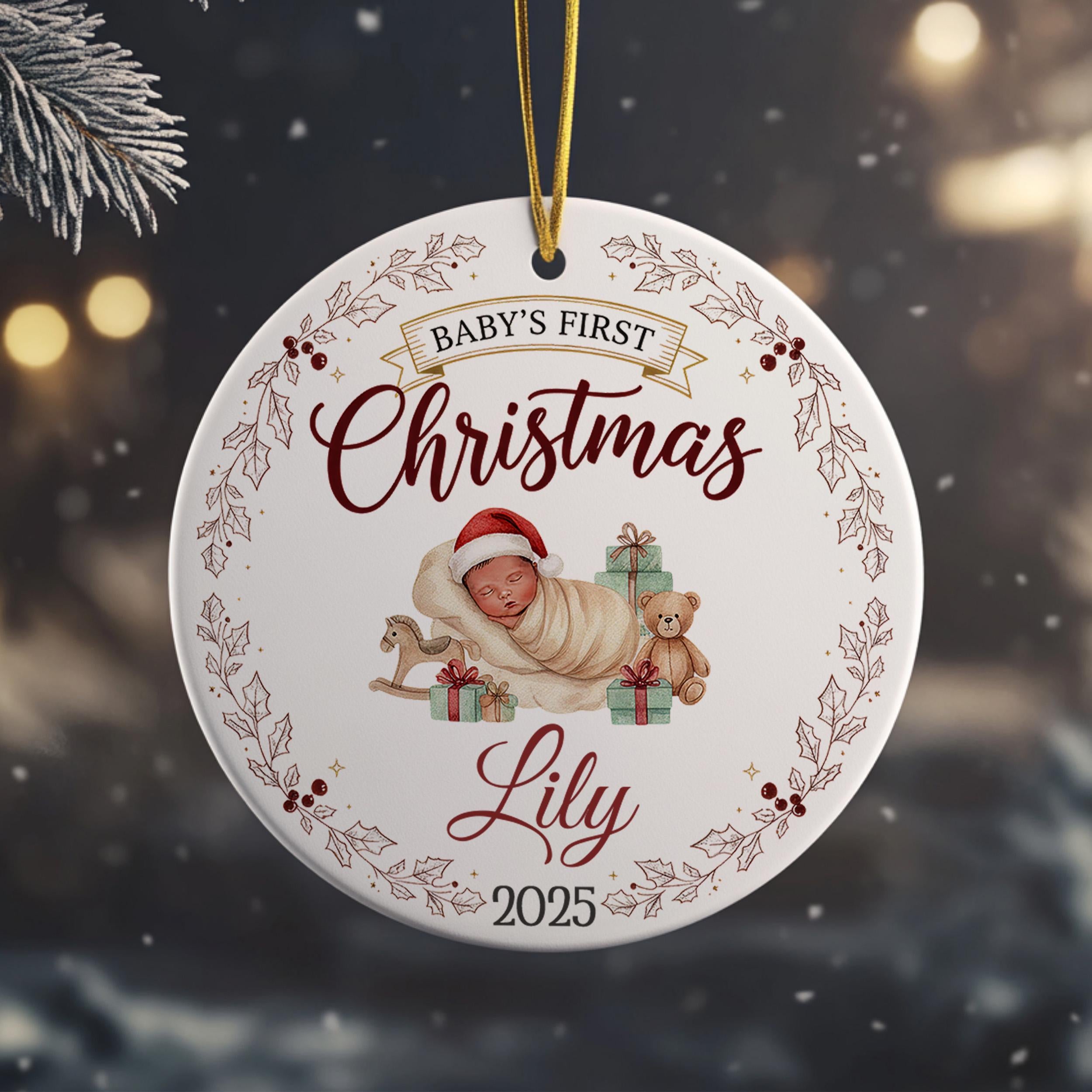 A white ornament with a baby and Christmas-themed decorations hanging from a string.