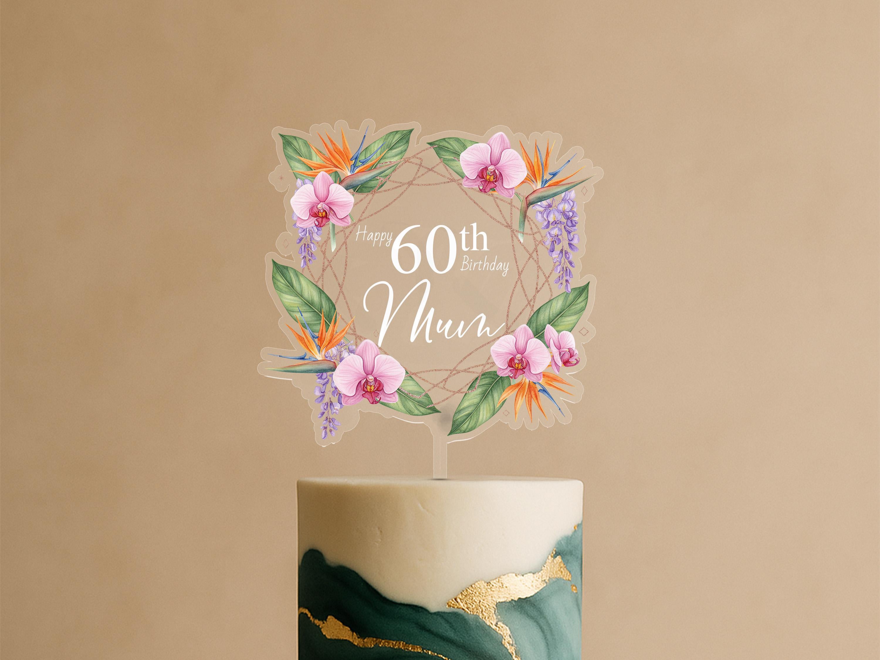 A birthday cake with a floral wreath topper that says "Happy 60th Birthday Mum".