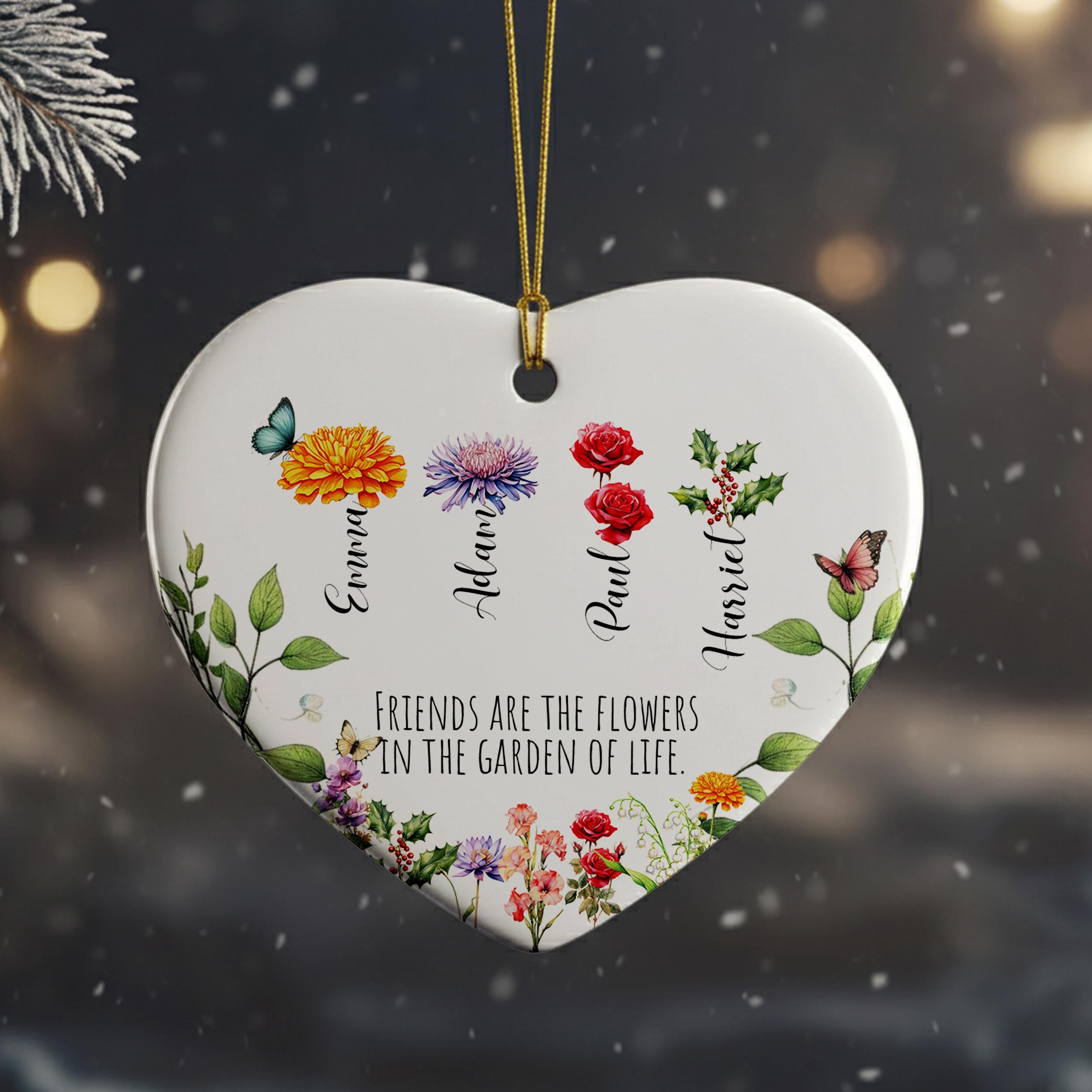 A heart-shaped ornament with a floral design and the text "Friends are the flowers in the garden of life" printed on it.
