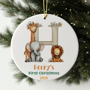 A white ornament with a giraffe, elephant, and lion, along with the text "Henry's First Christmas 2025".