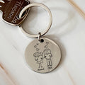 a keychain with a picture of a boy and a girl holding a heart