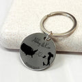 Personalised country map keychain with two engraved countries, names, connecting heart, and date, custom long distance relationship gift.