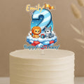 A birthday cake with a cartoon animal topper, specifically a lion and a dog, celebrating Emily's 2nd birthday.