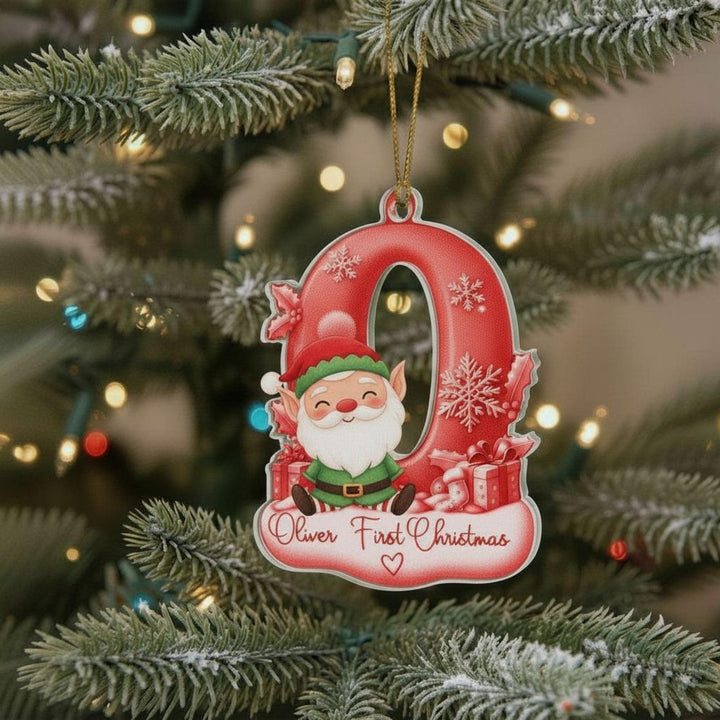 A red ornament shaped like the number 0, featuring a smiling Santa Claus figure, is hanging on a Christmas tree.