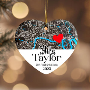 A heart-shaped ornament with a map of London and a red heart symbol, along with the text "Mrs & Mrs Taylor" and "Our first Christmas 2015".
