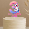 Personalised unicorn cake topper showing number 3 with rainbow unicorn design and custom name Ava on white birthday cake