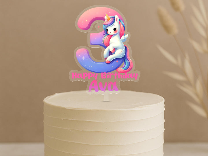 Personalised unicorn cake topper showing number 3 with rainbow unicorn design and custom name Ava on white birthday cake