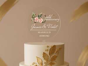 a white and gold wedding cake with a floral design