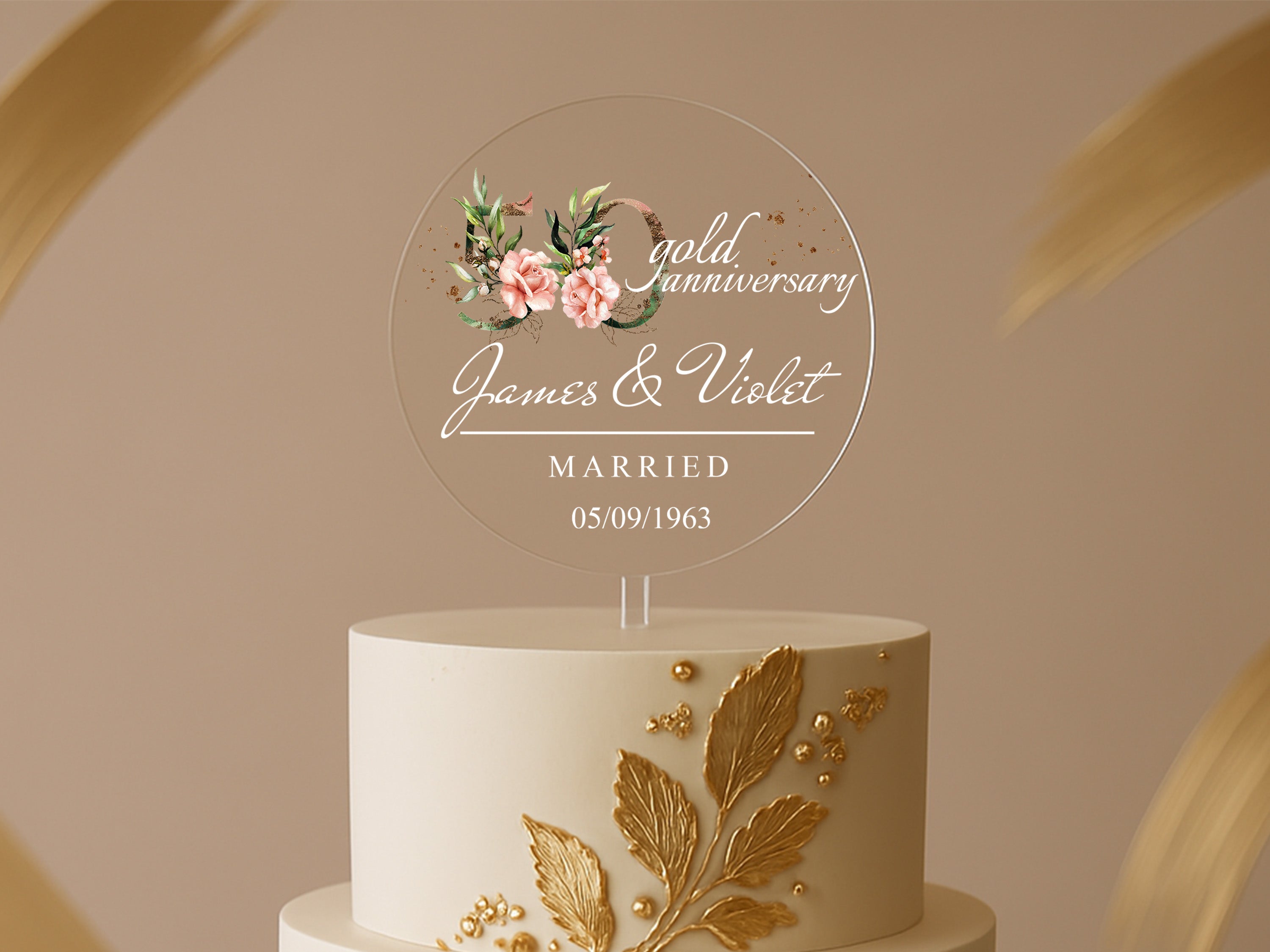 a white and gold wedding cake with a floral design