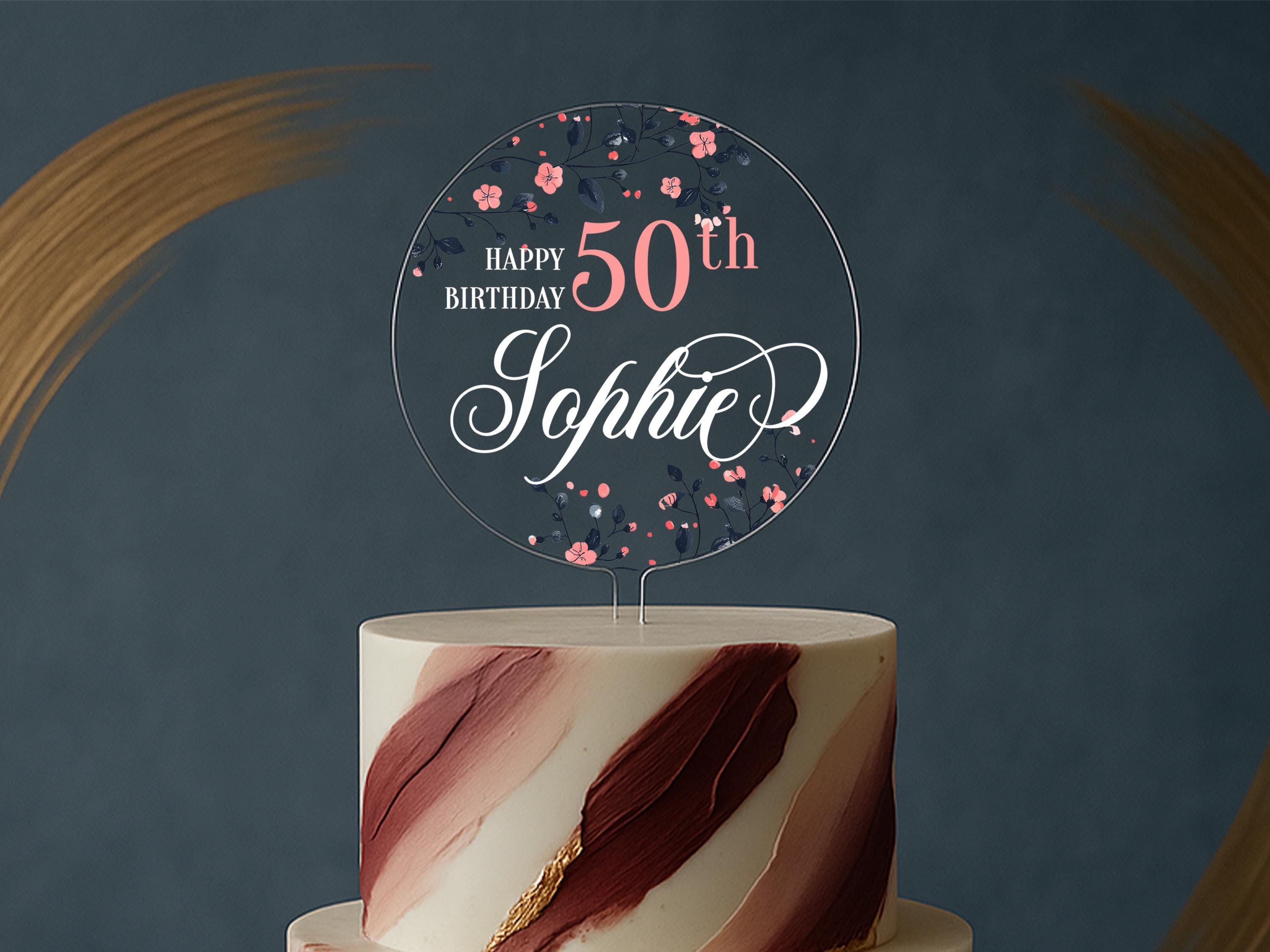 a white and red cake with a happy 50th sign on top
