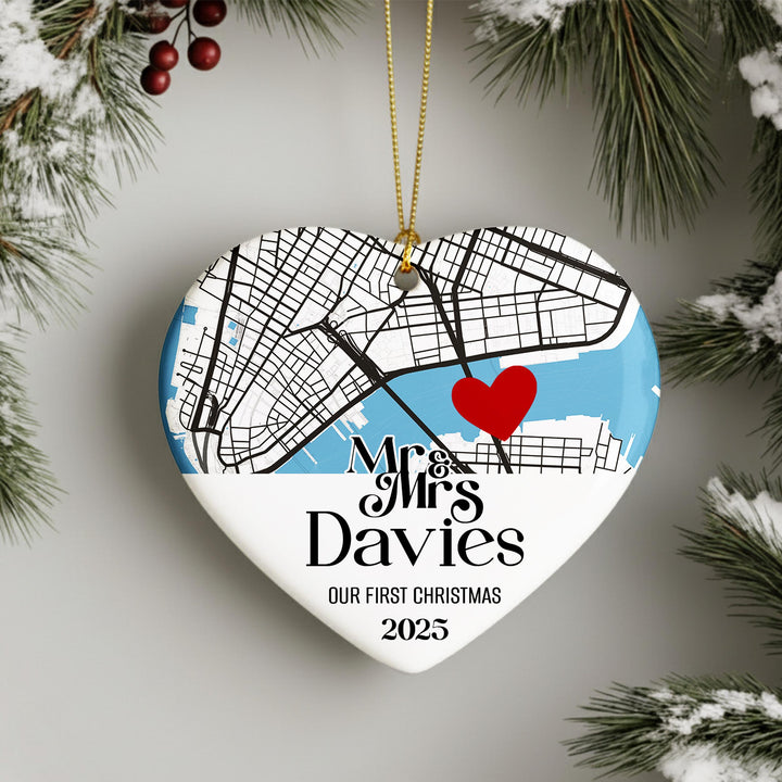 A heart-shaped ornament with a map of a city and a red heart, hanging on a string.