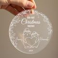 Personalised first Christmas together frosted acrylic ornament held in hand showing two cute bears wearing winter hats holding a heart, engraved text Our First Christmas Together, couple names James and Hannah on either side, 2025, surrounded by holly leaf and berry border with gold ribbon