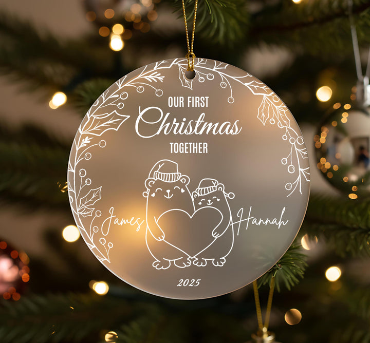 A Christmas ornament with a couple of bears holding hands and the text &quot;Our first Christmas together&quot; written on it.