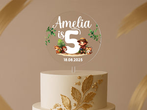 a white cake with a gold leaf decoration on top of it
