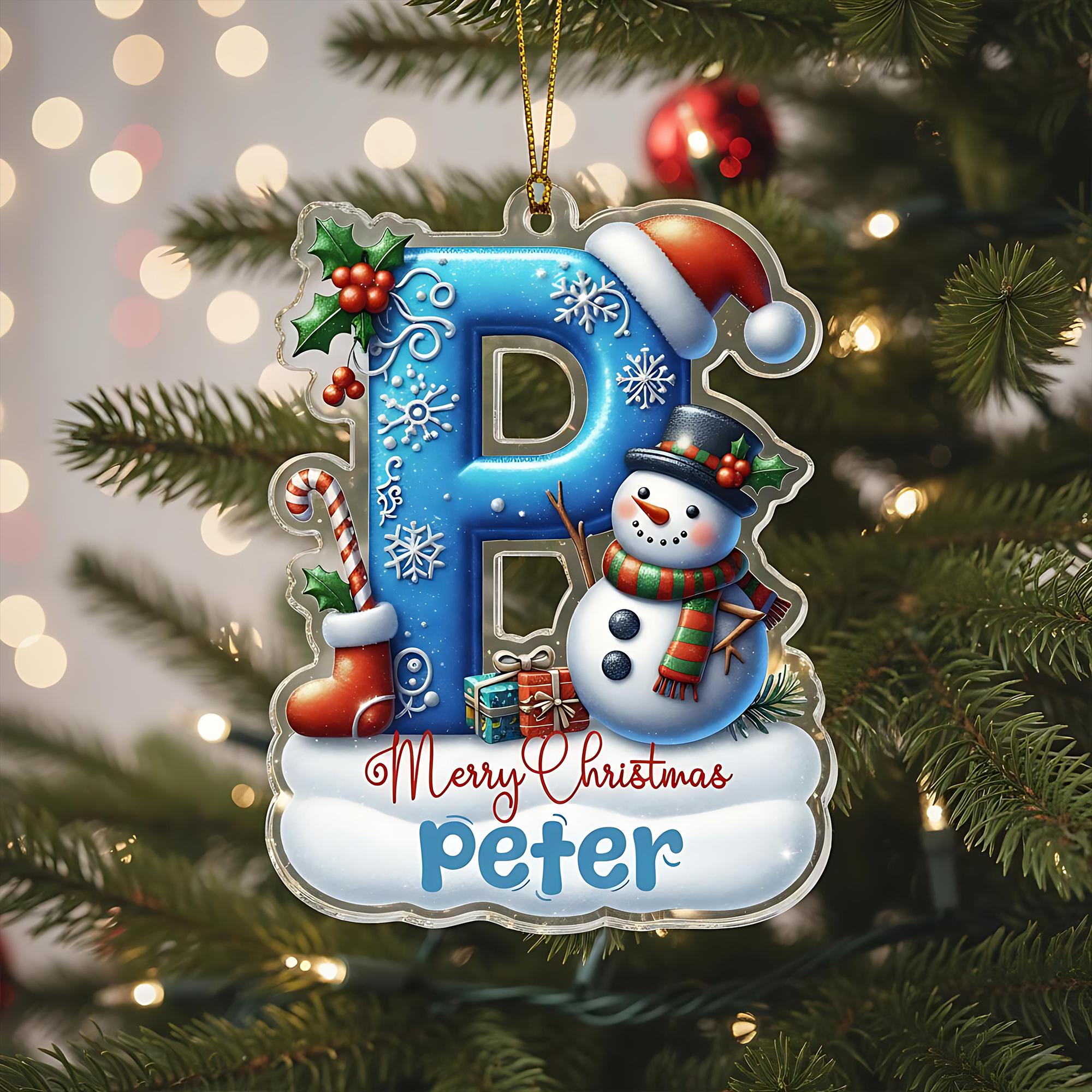 A clear ornament with a snowman and a letter "P" on a Christmas tree.