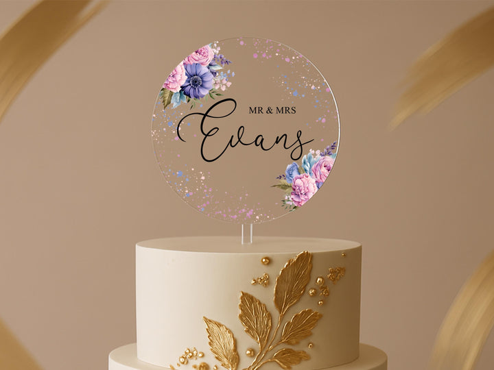 a wedding cake with a name and flowers on it
