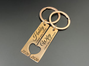 Personalised rose gold Hubby and Wifey keyring set with heart cut-out, engraved with “I love you more” and custom date, couples anniversary gift.
