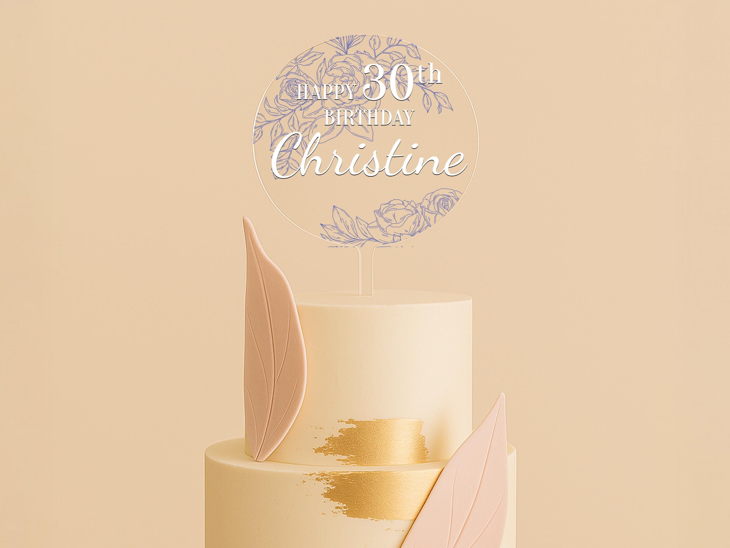 a white cake with pink and gold decorations
