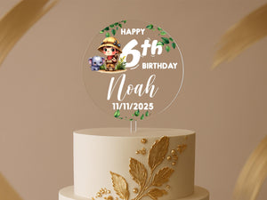 a white and gold birthday cake with a picture of a boy on top