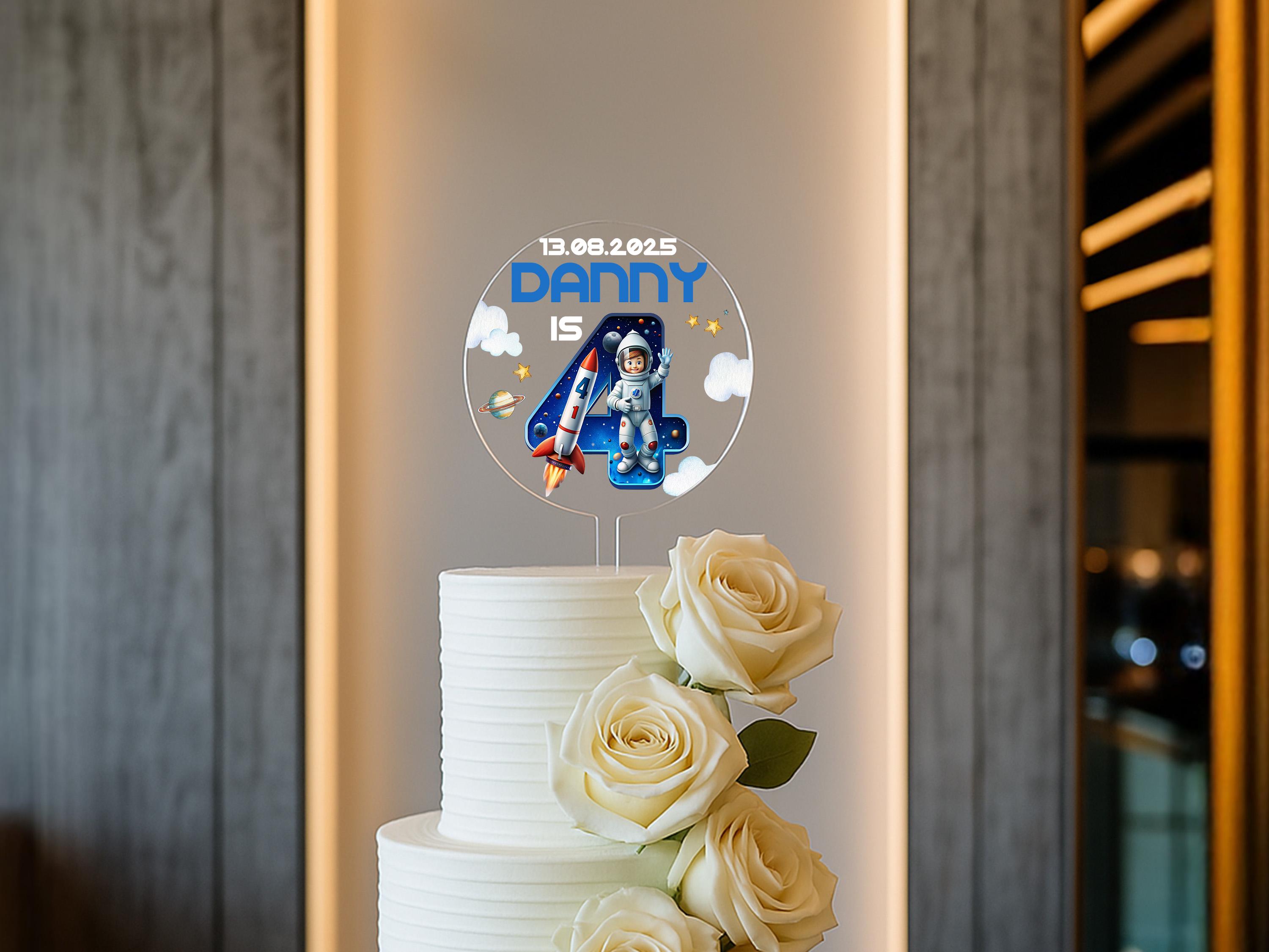 Space themed birthday cake with personalised topper and vibrant illustrations
